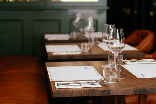 a glass of wine sitting on top of a wooden table