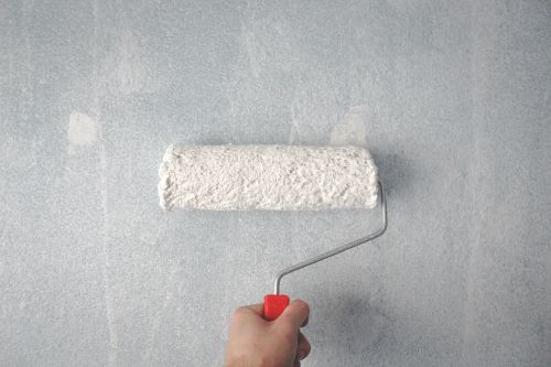 a  hand holding a paint roller