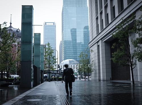 a person walking down a street holding an umbrella